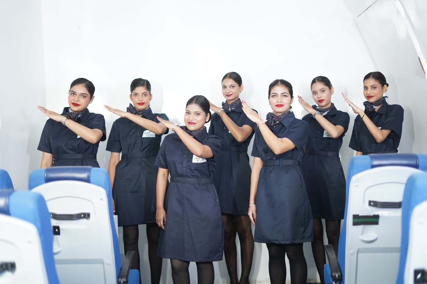 Cabin crew trainees practising safety demonstration positions